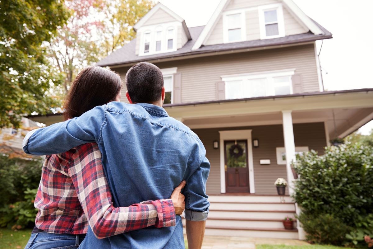 Rear View Of Loving Couple Walking Towards House