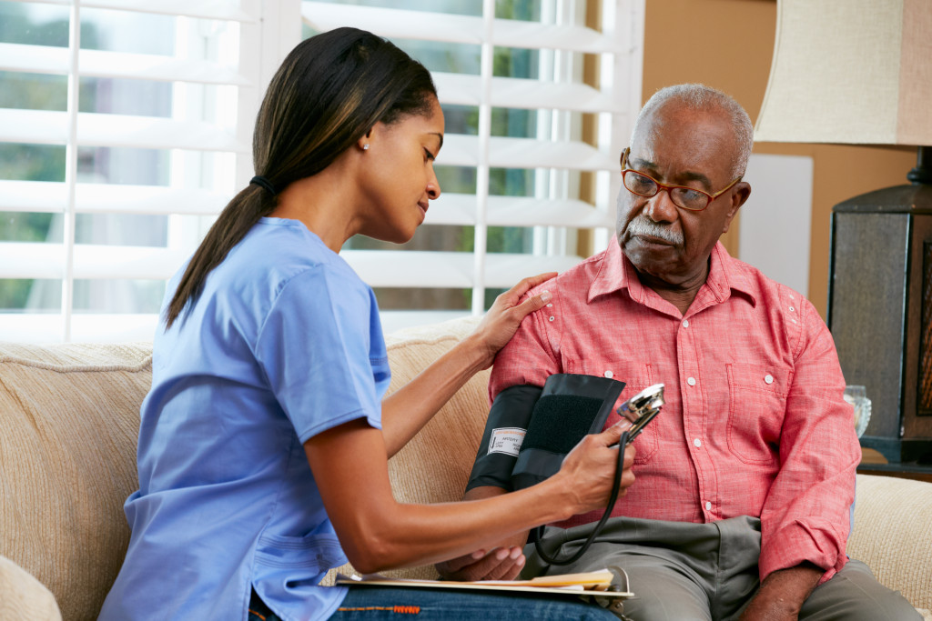 healthcare worker checking blood pressure