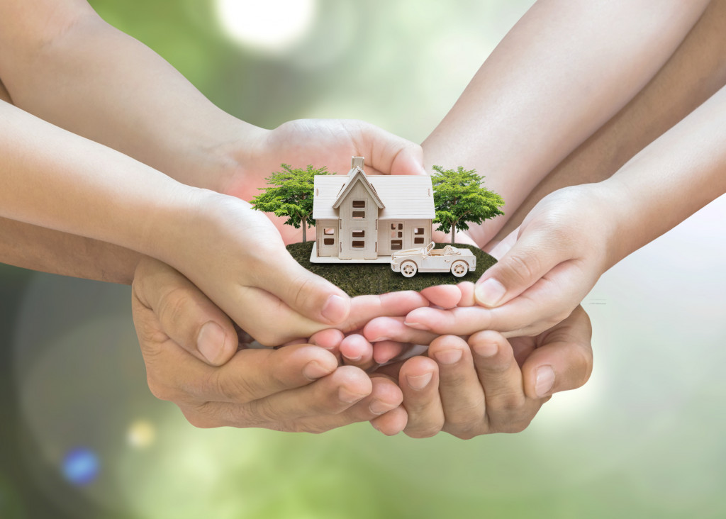 family holding a model house