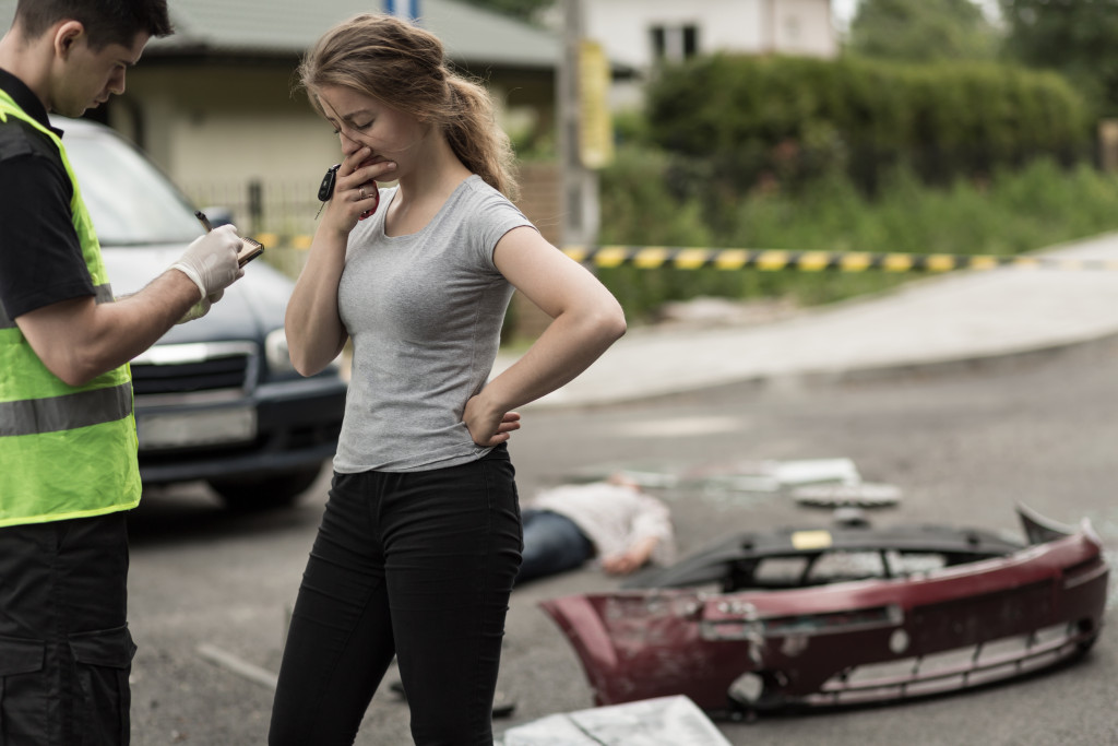 A terrified woman talking to a police after a car crash