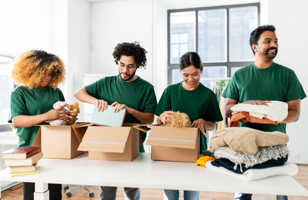 group of young volunteers packing donations