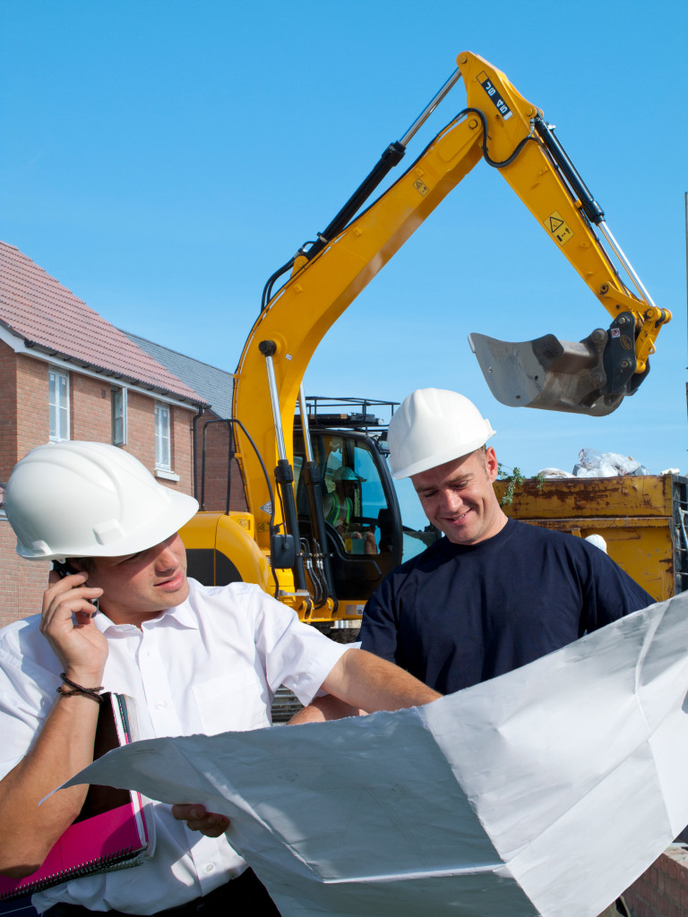 to men reviewing a project plan in construction