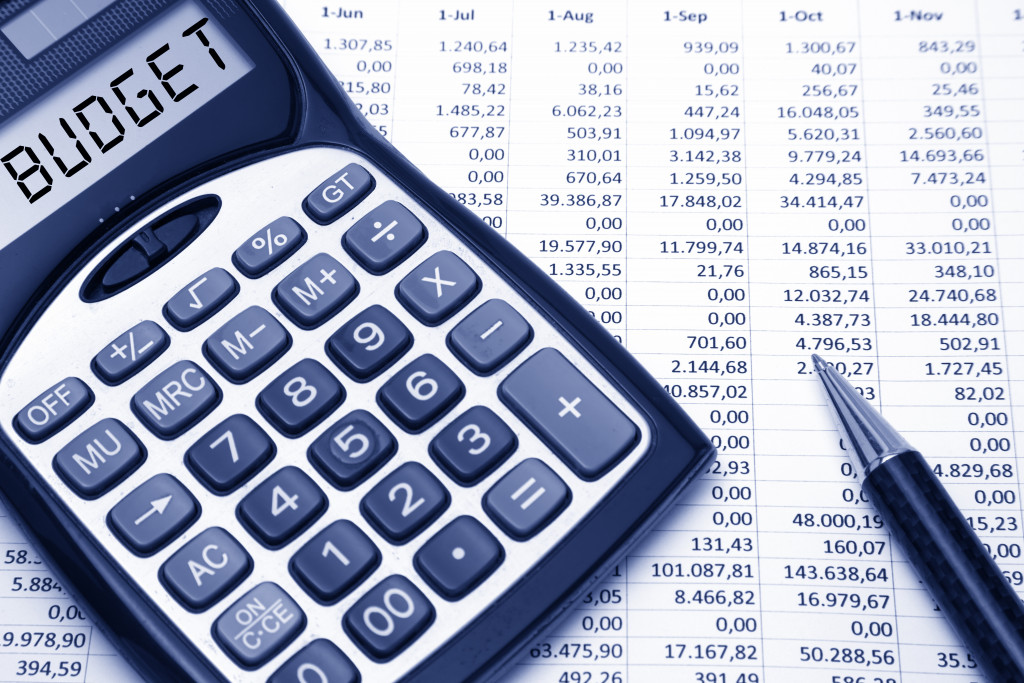 calculator with word budget on top of spreadsheet financial budget