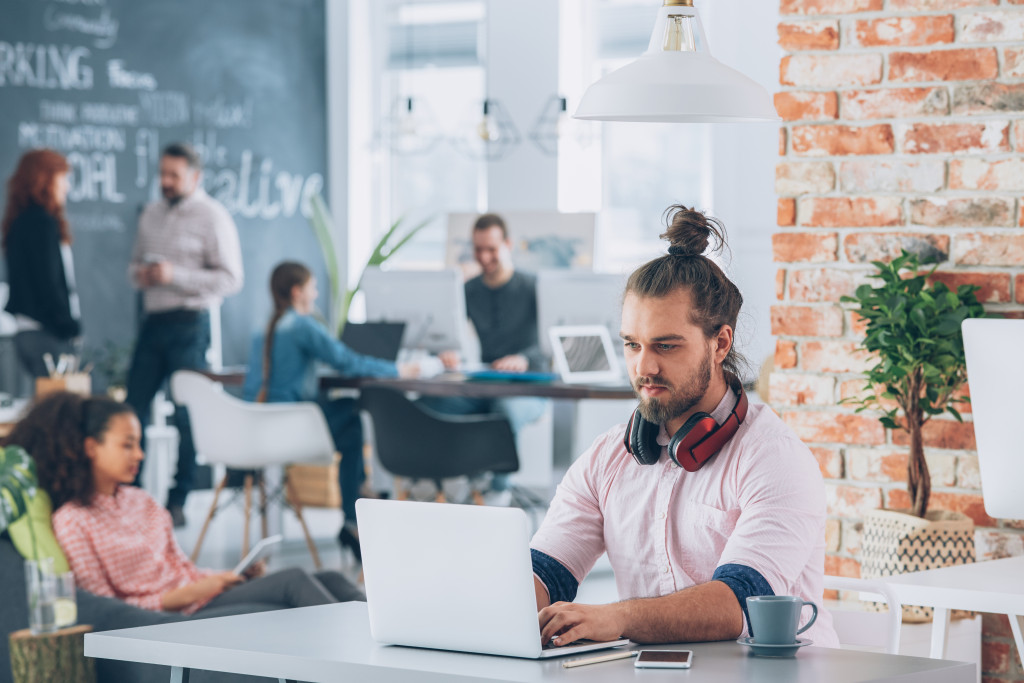 people at a co working space busy 