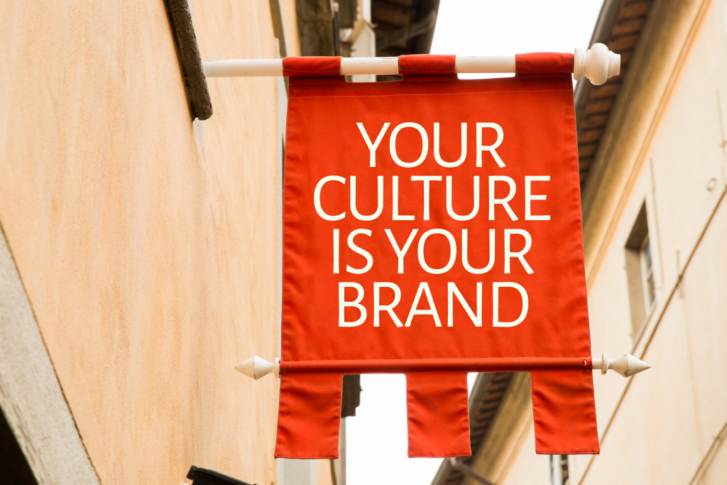 Banner showing the phrase your culture is your brand hanging from a wall.