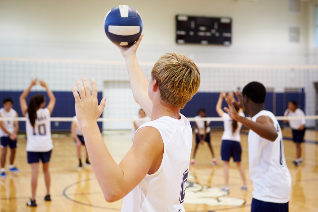 students playing volleyball at the gym