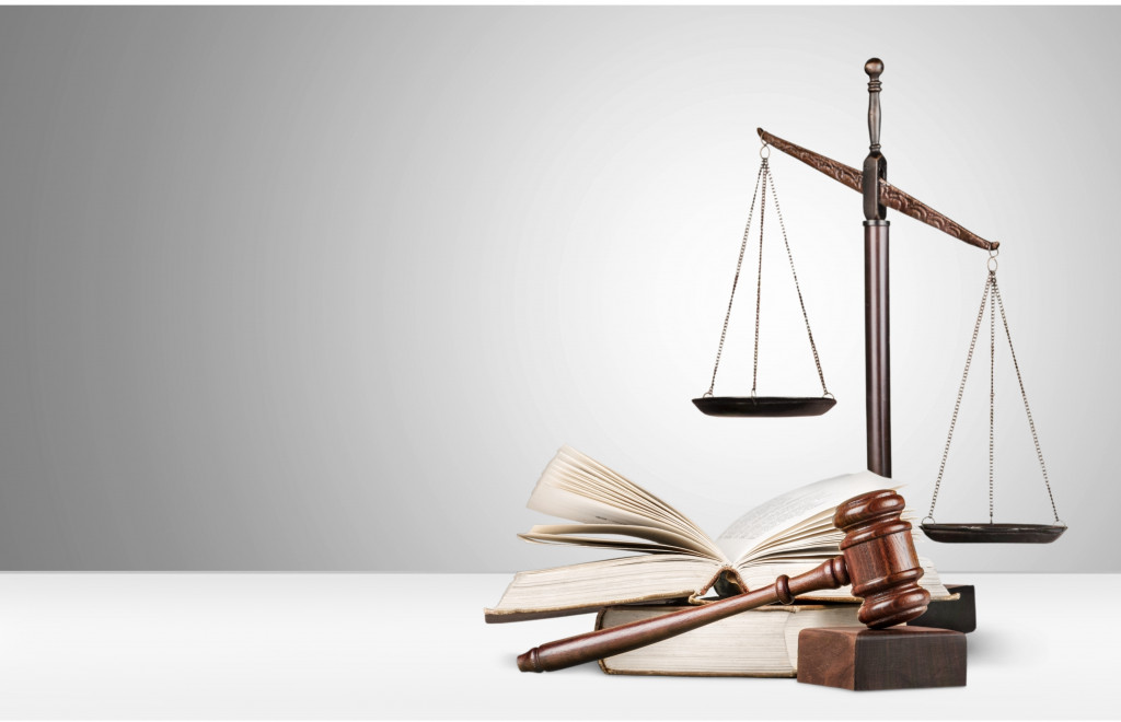 A scale, book, and wooden gavel