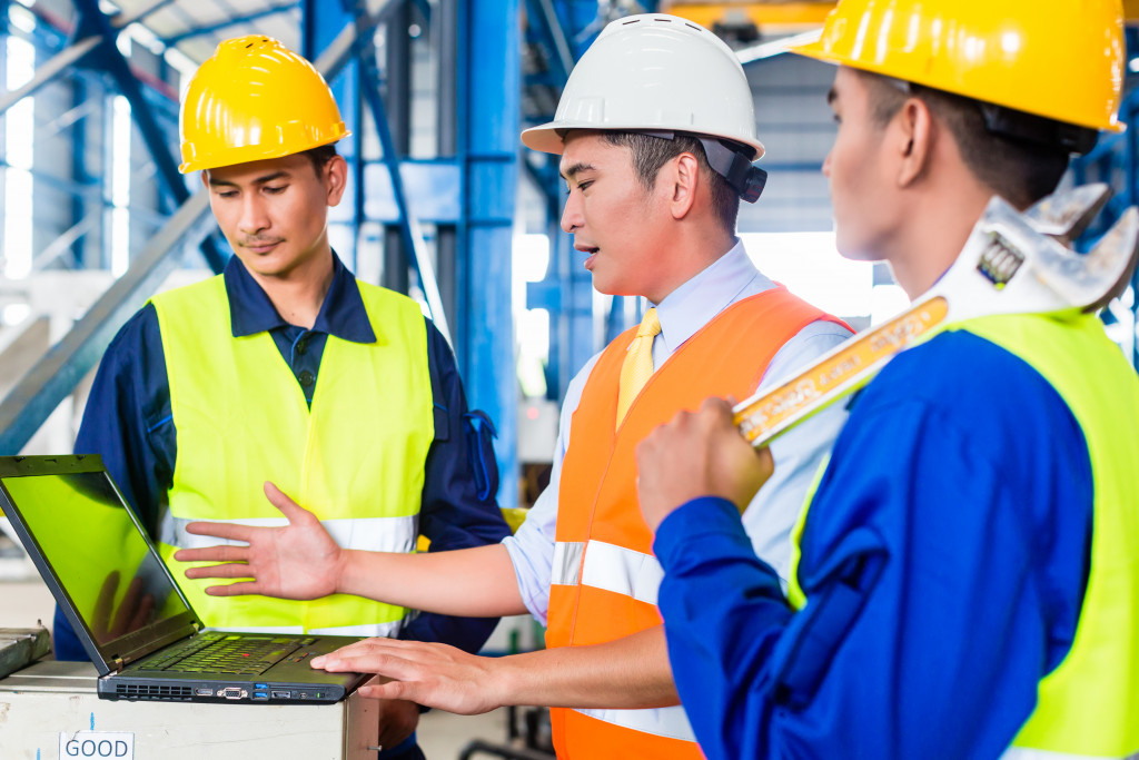 A construction manager training his workers