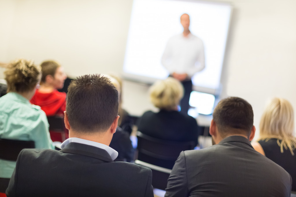 man speaking in front of an audience