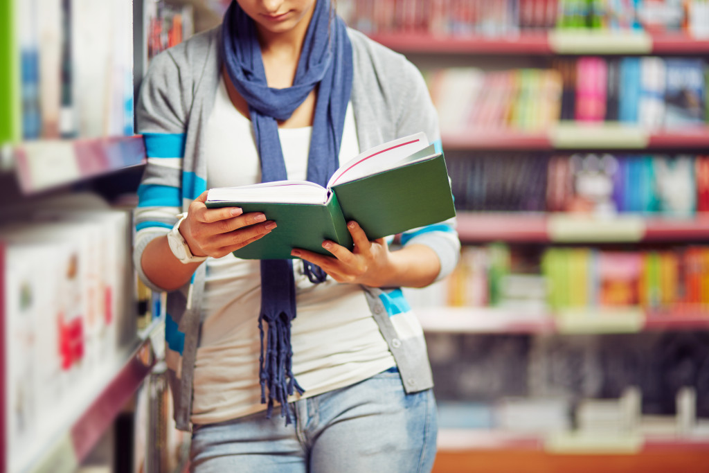 woman reading a book in the shop