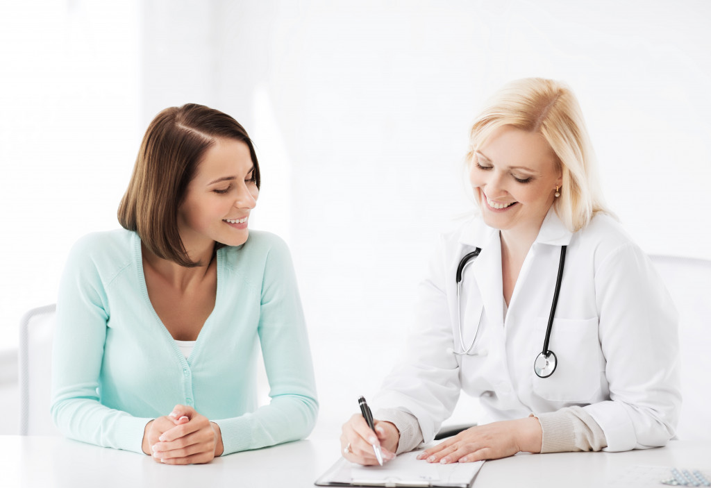 female patient and doctor smiling together