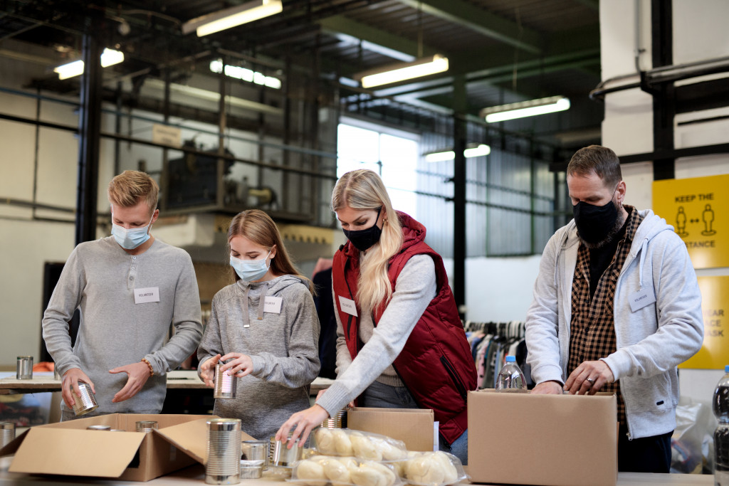 Volunteers organizing donated food at a donation center.