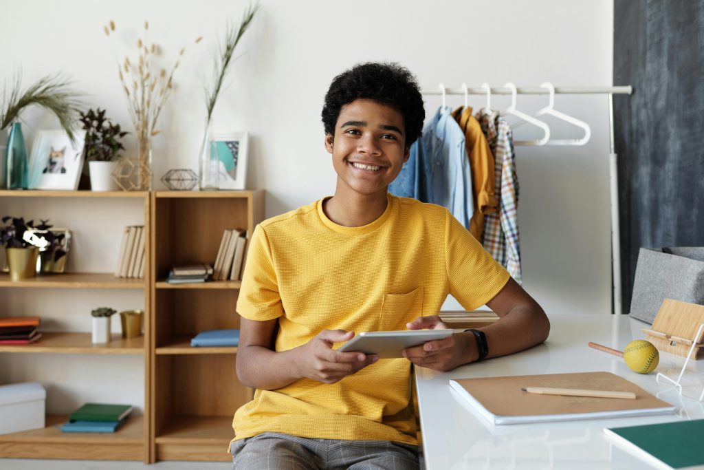 Boy in yellow shirt using his tablet