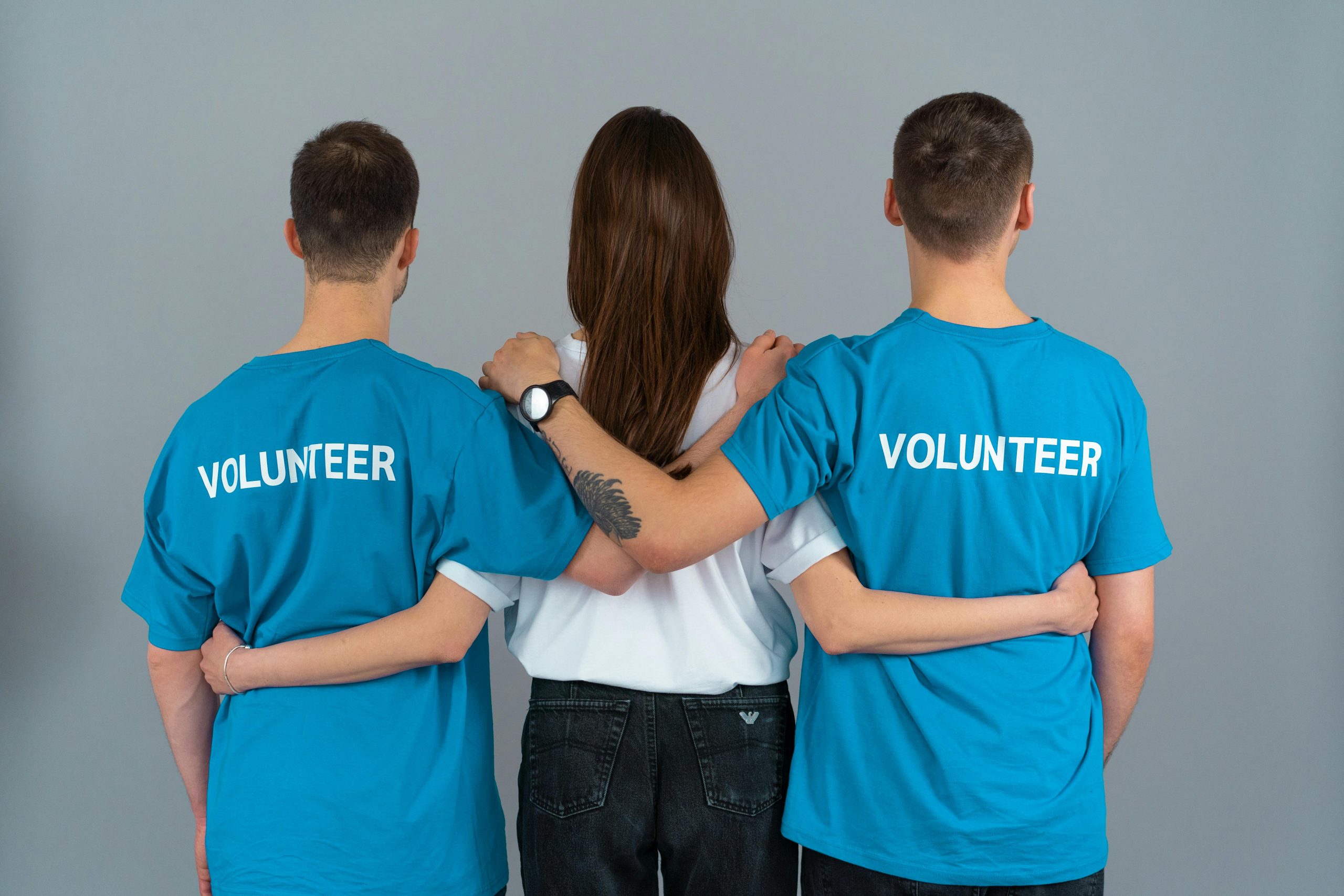 group of volunteers with arms interlocked